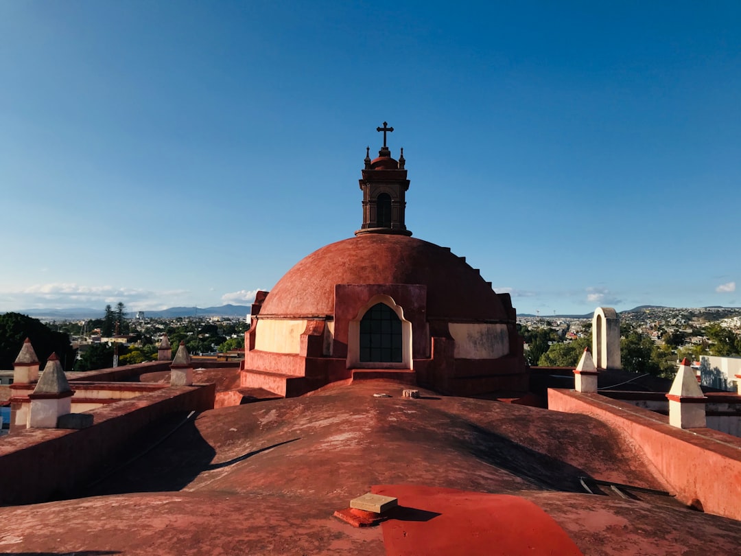 brown and white concrete building under blue sky during daytime