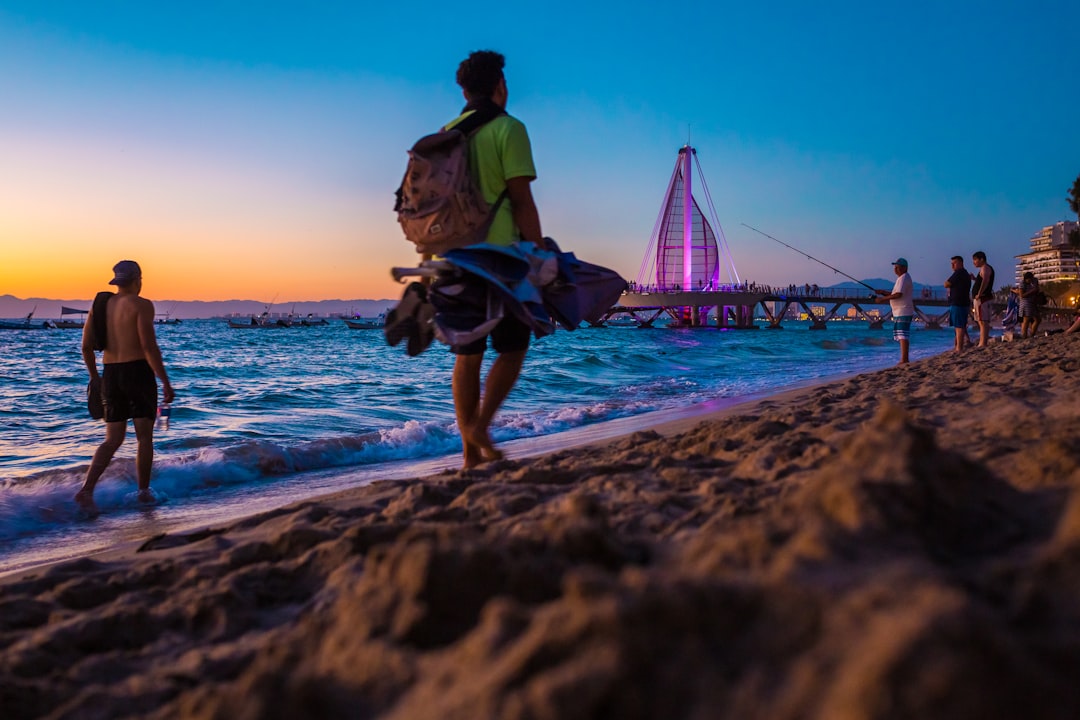 a group of people walking on a beach